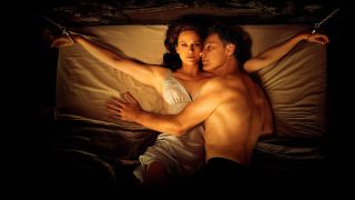 Jessie lies handcuffed to a bed with Gerald on top of her in Netflix movie Gerald's Game