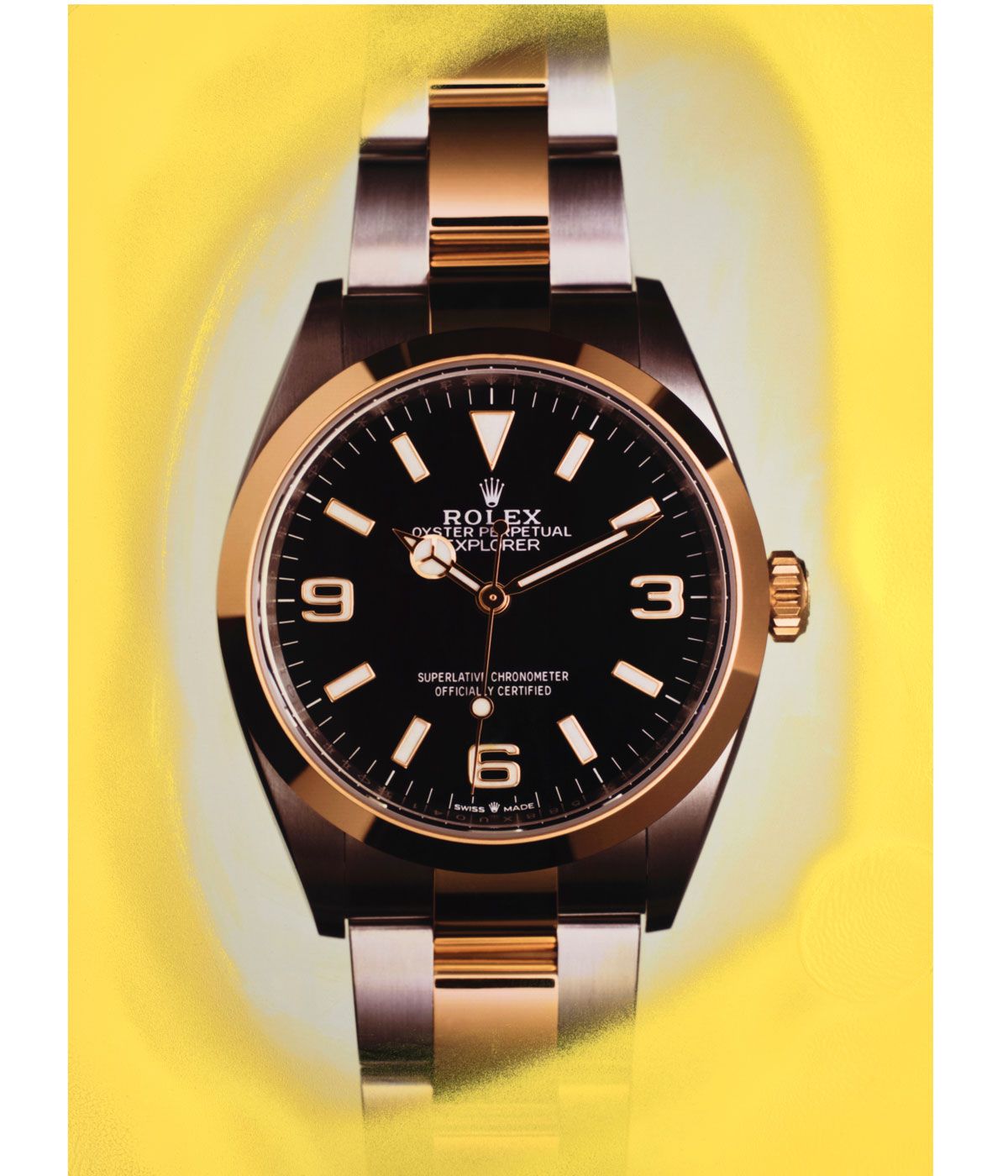 Gold Rolex watch with a yellow background 