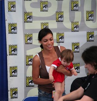 Instead of asking for an autograph or a photo, one of Rosario Dawson's fans hands over her baby. Only at Comic-Con...