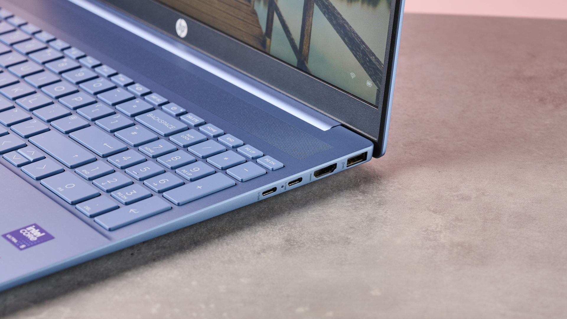 Close-up of right-side ports on HP Pavilion 16, on desk with pink wall in background