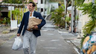 DI Neville Parker (Ralf Little) carrying groceries in Death in Paradise season 12