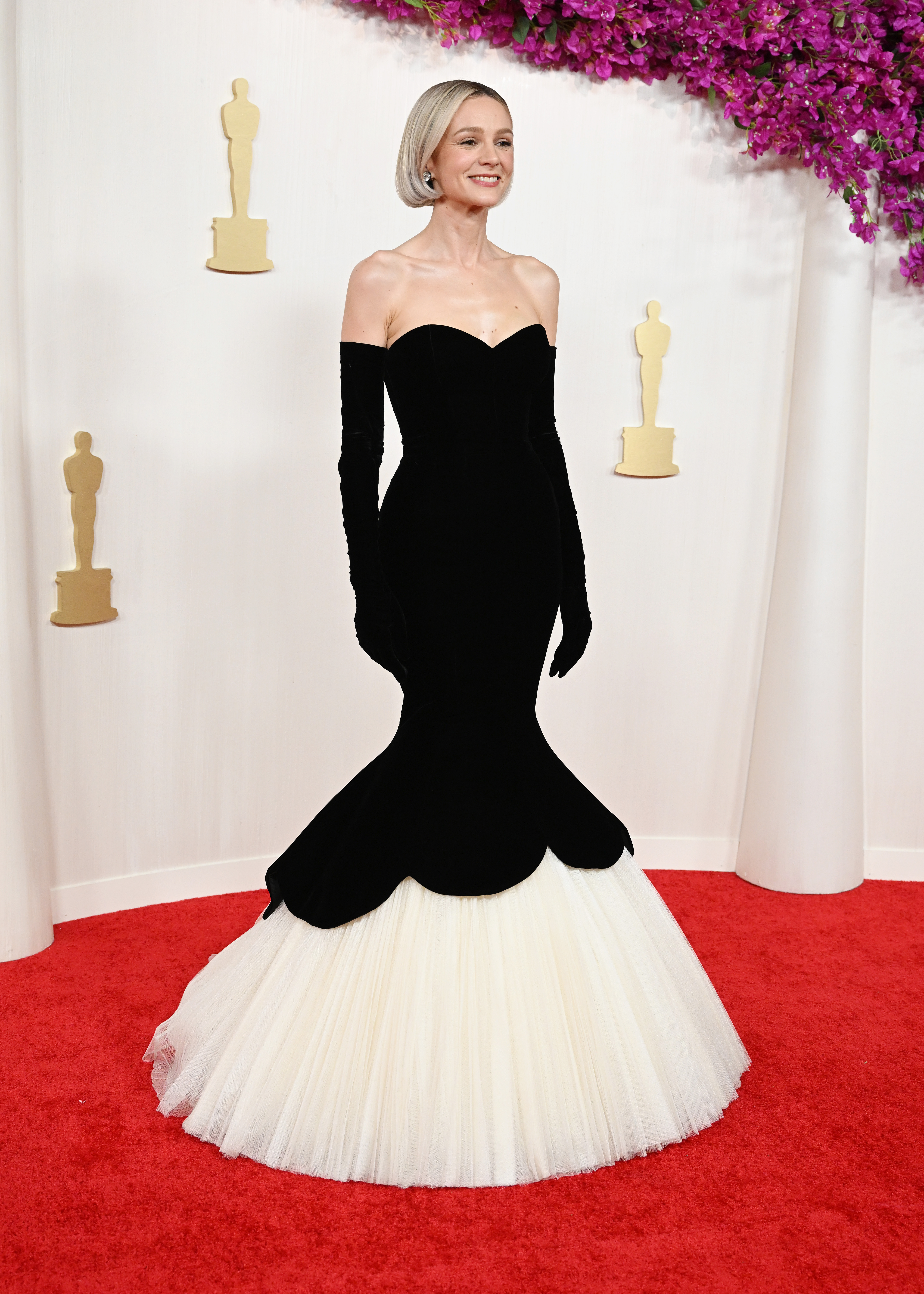 Carey Mulligan wears a strapless mermaid dress by Balenciaga on the 2024 Oscars red carpet