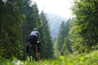 Image shows Anna cycling in the Carpathenian mountains in Slovakia