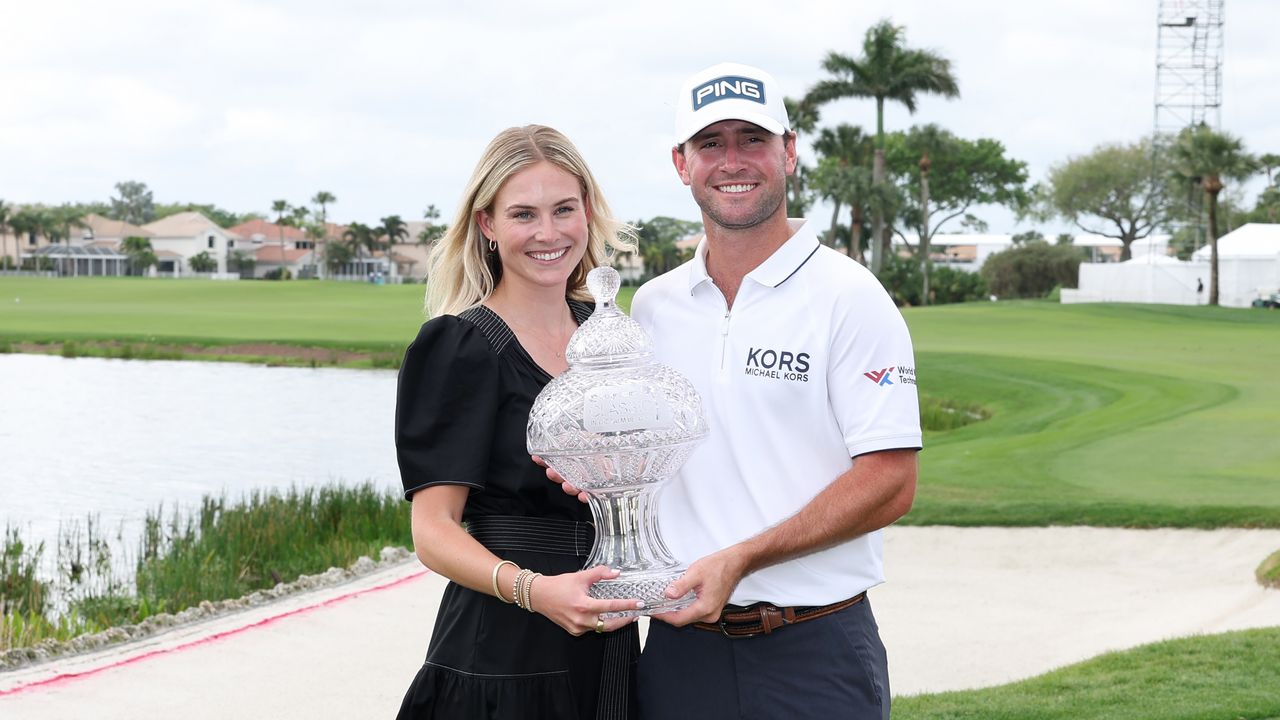 Sally Merrill and Austin Eckroat pose with the 2024 Cognizant Classic trophy