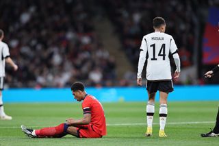 Jamal Musiala of Germany walks past Jude Bellingham of England during the UEFA Nations League match between England and Germany at Wembley Stadium, London on Monday 26th September 2022.