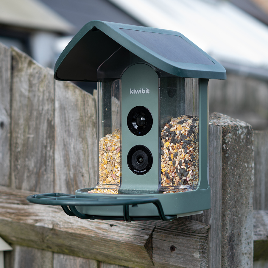 The Kiwibit Beako attached to a garden fence
