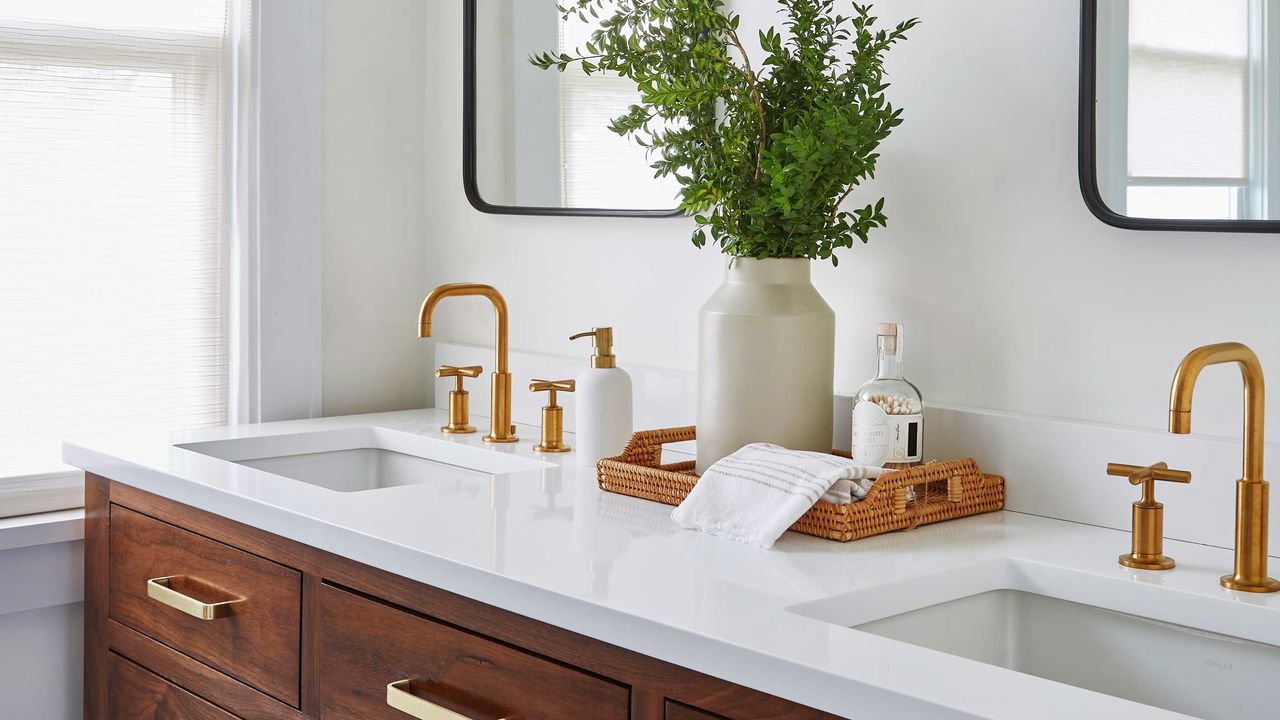 a bathroom vanity with towels and soap dispensers