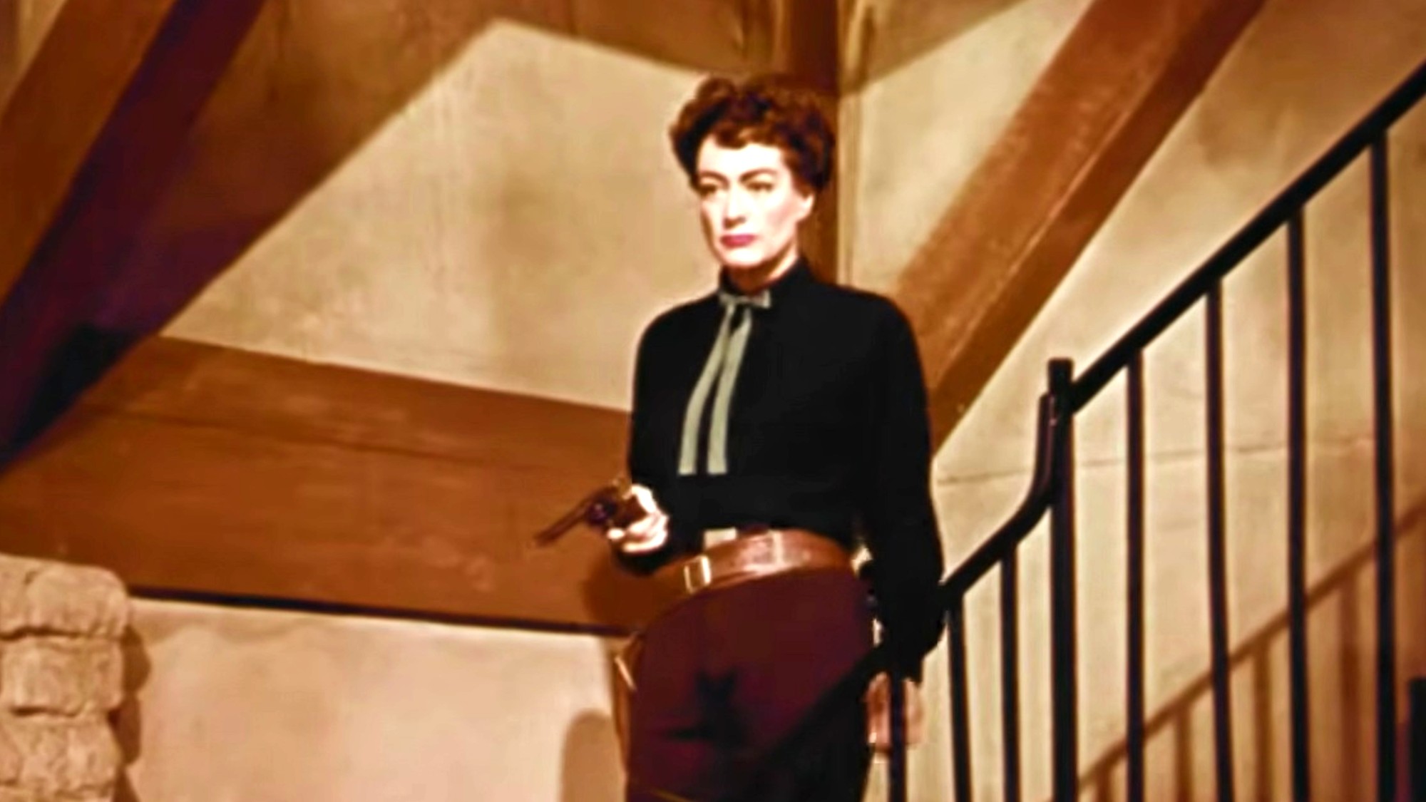 Joan Crawford aiming a pistol in Johnny Guitar