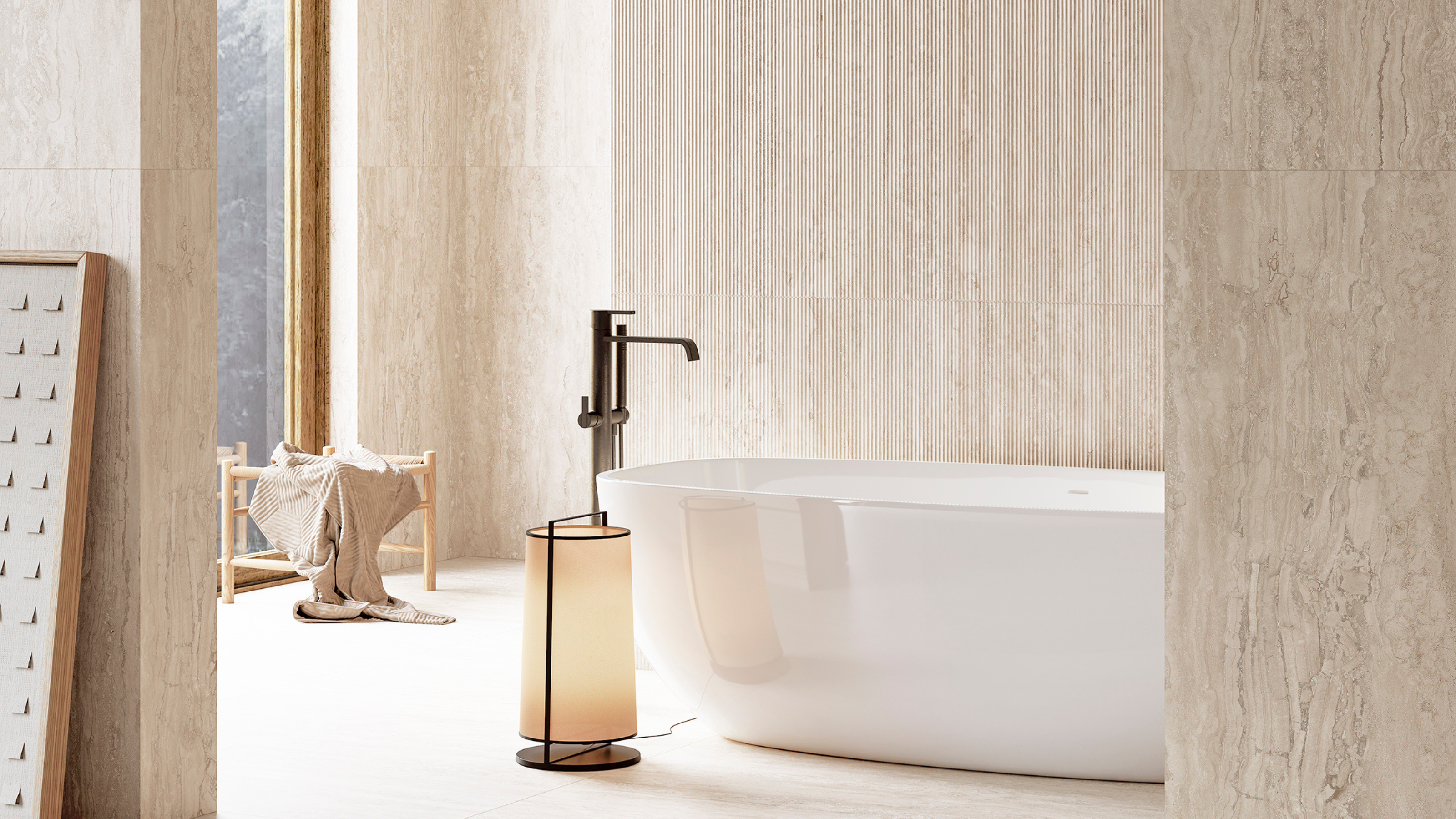 travertine-look tiled bathroom with freestanding tub