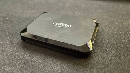 Crucial X9 external SSD on a desk mat