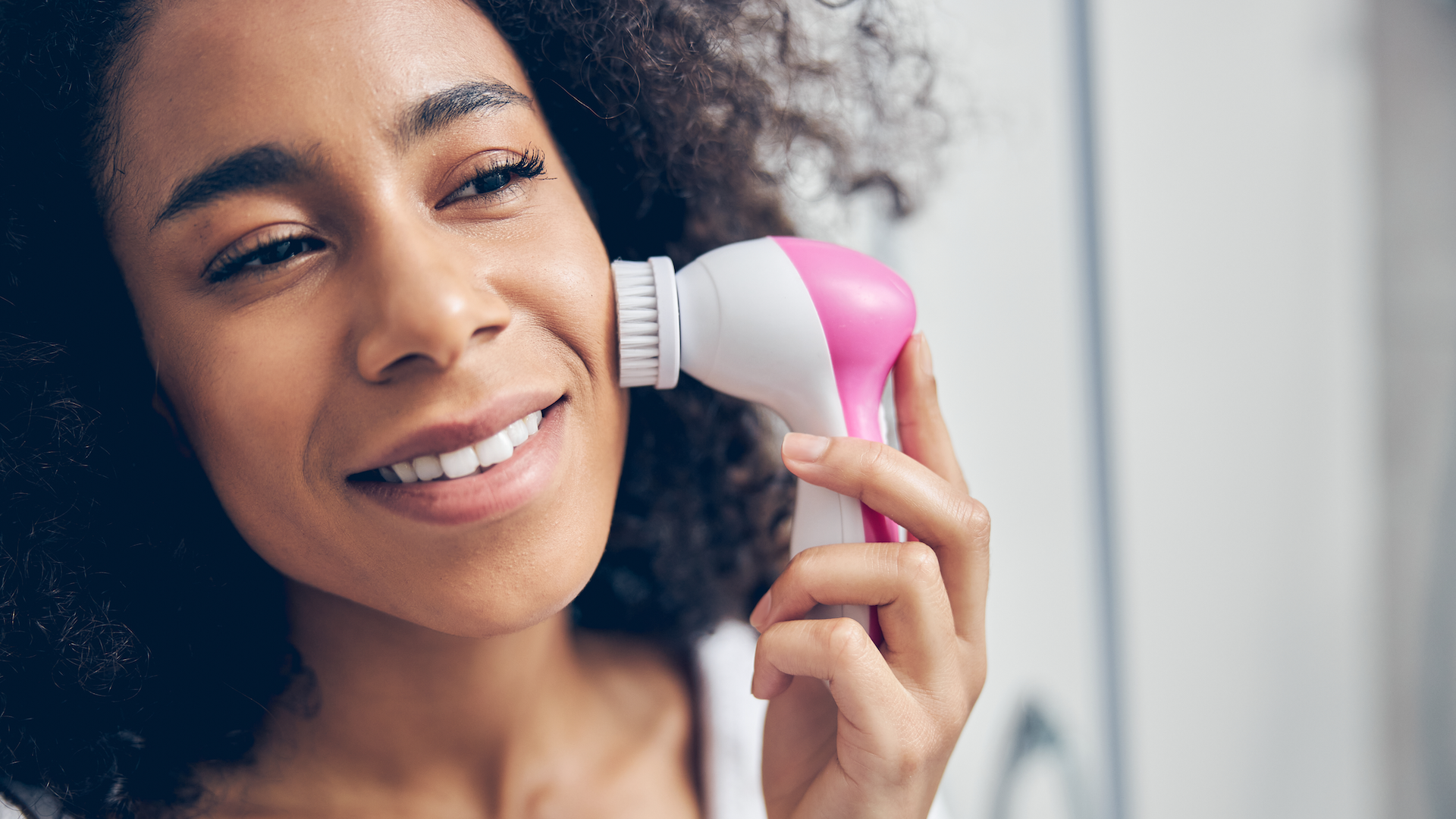 Woman using a facial cleansing brush