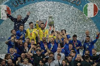 Italy players and staff celebrate with the European Championship trophy after winning Euro 2020.