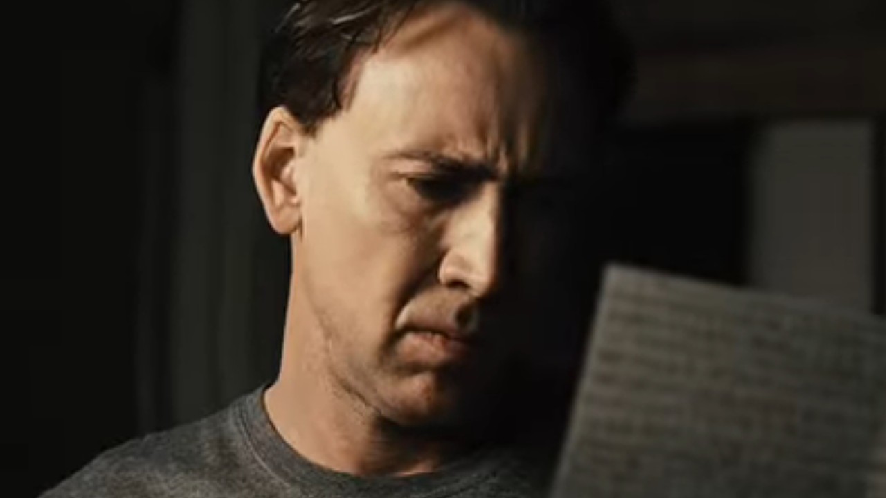 Nicolas Cage glaring at a sheet of paper in Knowing