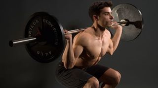 Man performing barbell squat