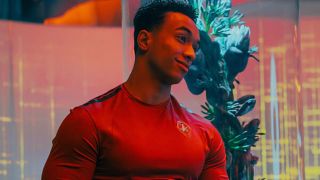 Caleb smiling while draped in red lighting in Star Trek: Starfleet Academy.