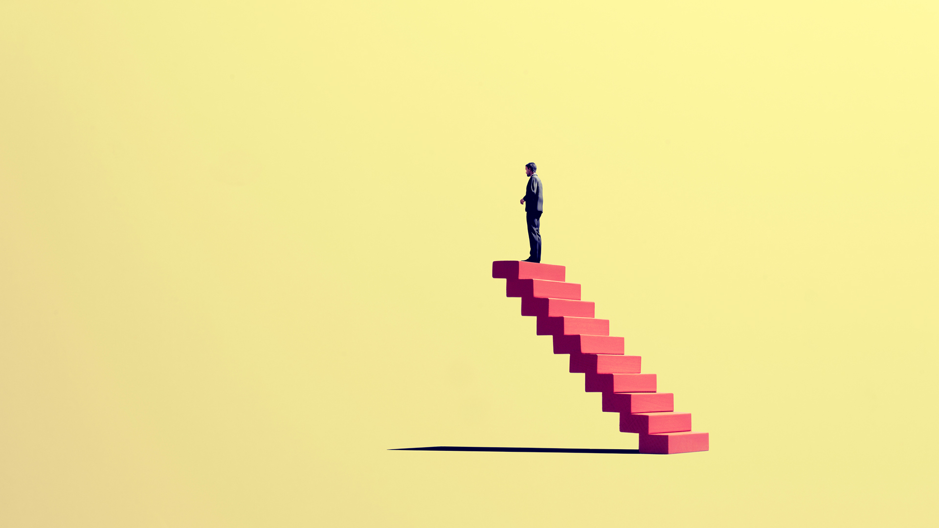 A man standing on top of a red staircase leading nowhere against a yellow void, symbolizing the loss of junior roles to AI and future talent crisis it could spark.