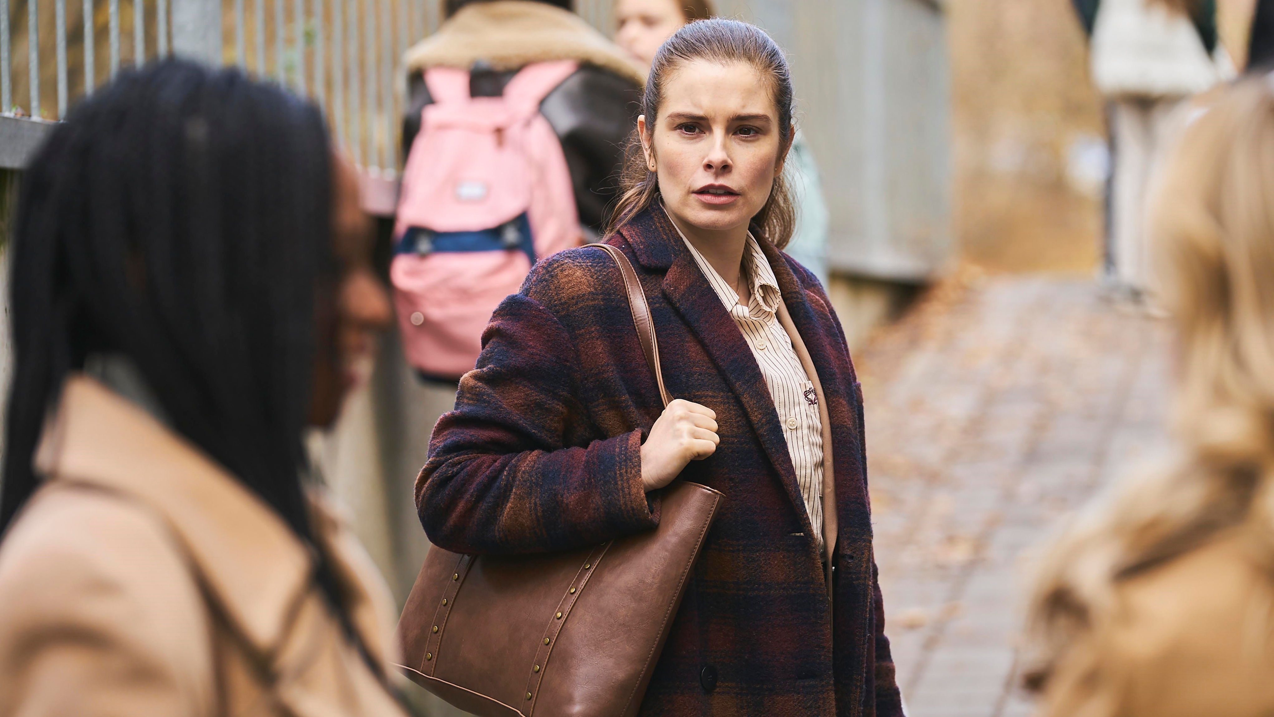 Joanna looking cross at other mum sat the school gate in The Rumour