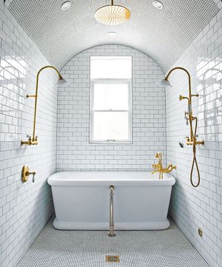 Small bathroom with white metro tiles, bath and rainwater shower
