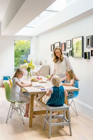 family in dining room extension photographed by polly eltes