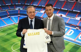 Eden Hazard poses with Real Madrid president Florentino Perez after signing for Real Madrid in 2019.