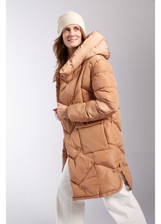 Model wears tan padded coat