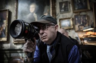 An image of cinematographer Barry Sonnenfeld behind the lens of a camera.