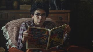 George looks up from reading a comic book in Netflix's Lockwood & Co