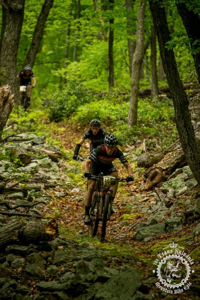 Spensor Paxson hits a rock garden on the enduro segment followed by several riders