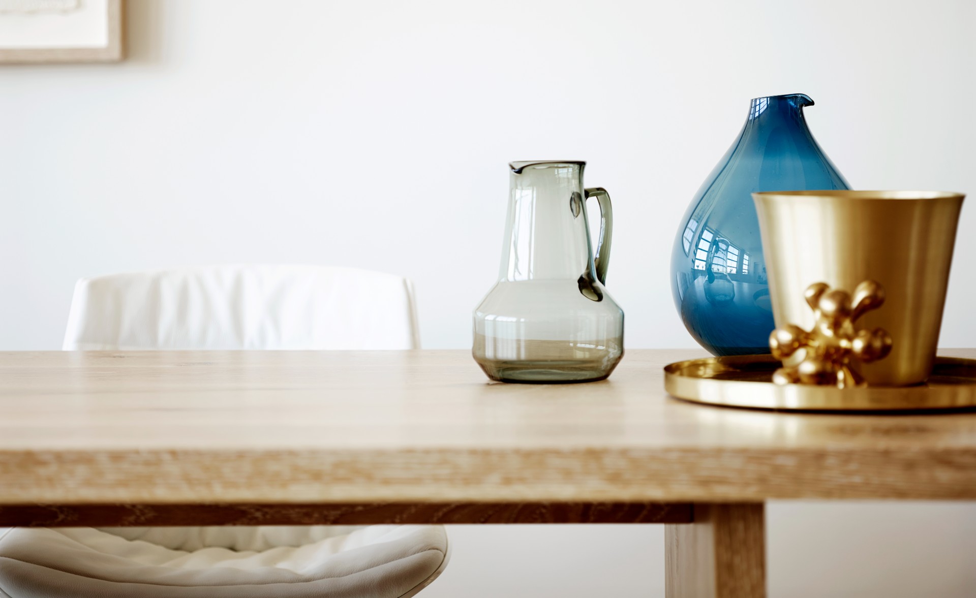 Room includes chairs, table, glass, mug, jar on the table