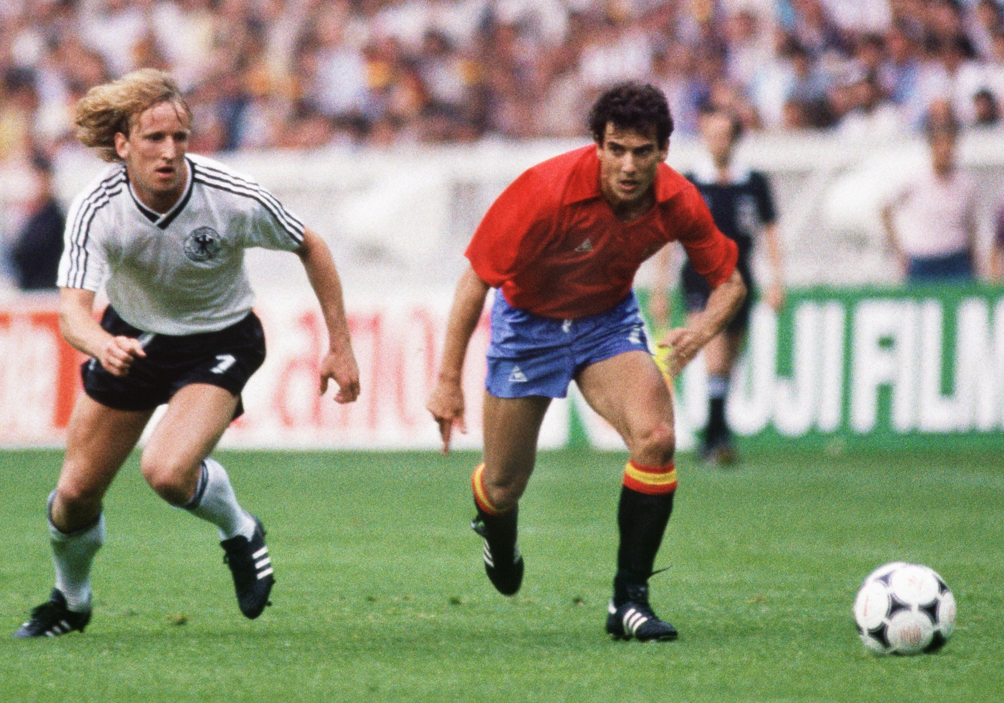 West Germany's Andreas Brehme and Spain's Juan Señor run after the ball in a game at Euro 1984.