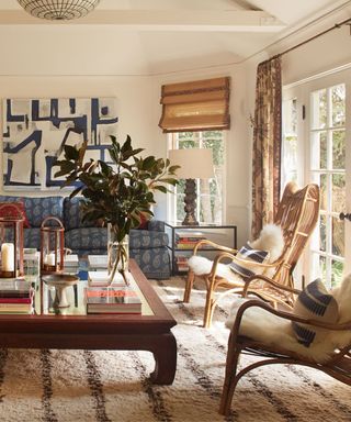 sunroom with bamboo blinds and rattan chairs with blue accents