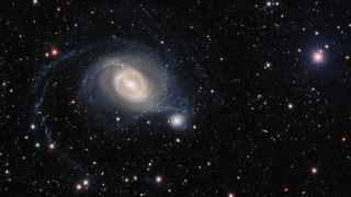 This image shows a wider view of the interacting galaxies NGC 1512 and NGC 1510 as seen by the Dark Energy Camera on the Víctor M. Blanco 4-meter Telescope at Cerro Tololo Inter-American Observatory in Chile operated by the National Science Foundation's NOIRLab.
