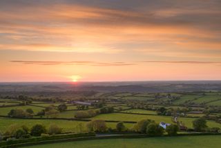 Sunset over beautiful rolling Devon countryside, Devon, England. Summer (June) 2013