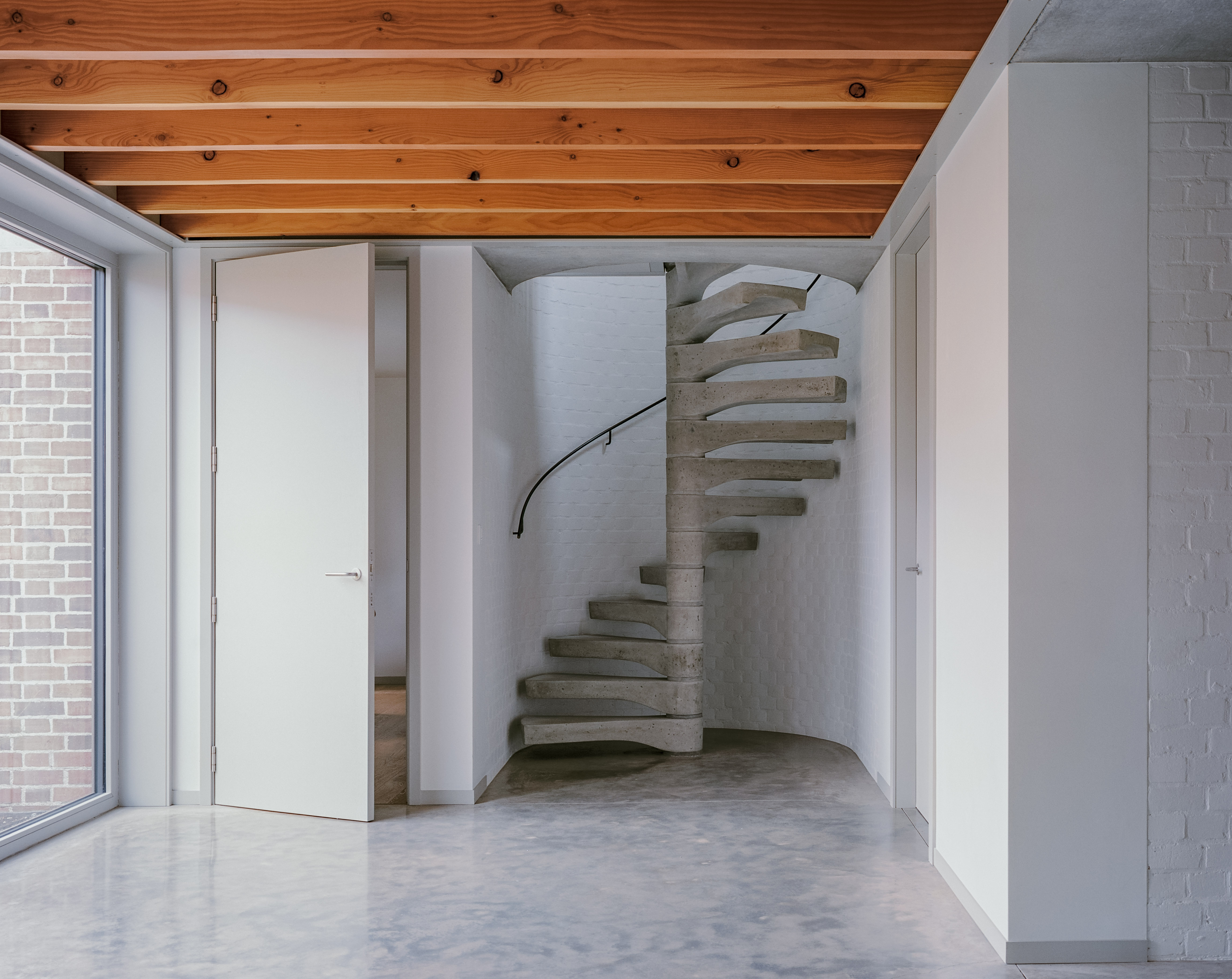 Internal hallway showing the prefabricated concrete stair leading up to one of the first floor bedrooms