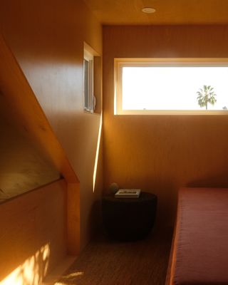 sleeping area with horizontal slit window at the Monon Guesthouse by Jerome Byron