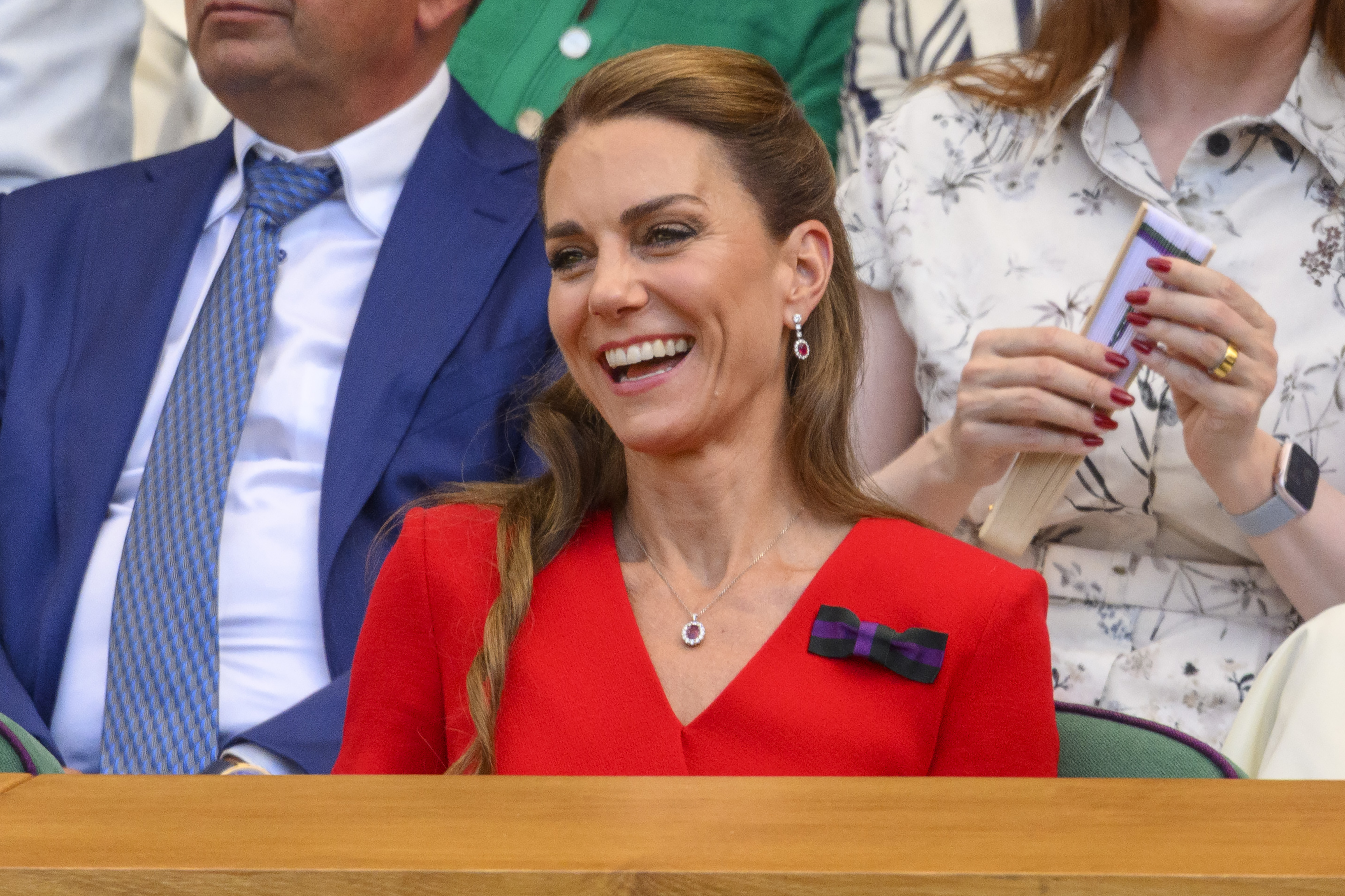 Princess Kate sitting at Wimbledon in a red dress