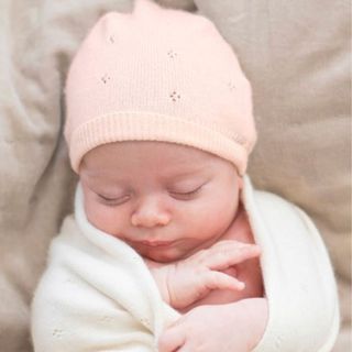 best baby gifts - sleeping baby wearing a pink cashmere hat