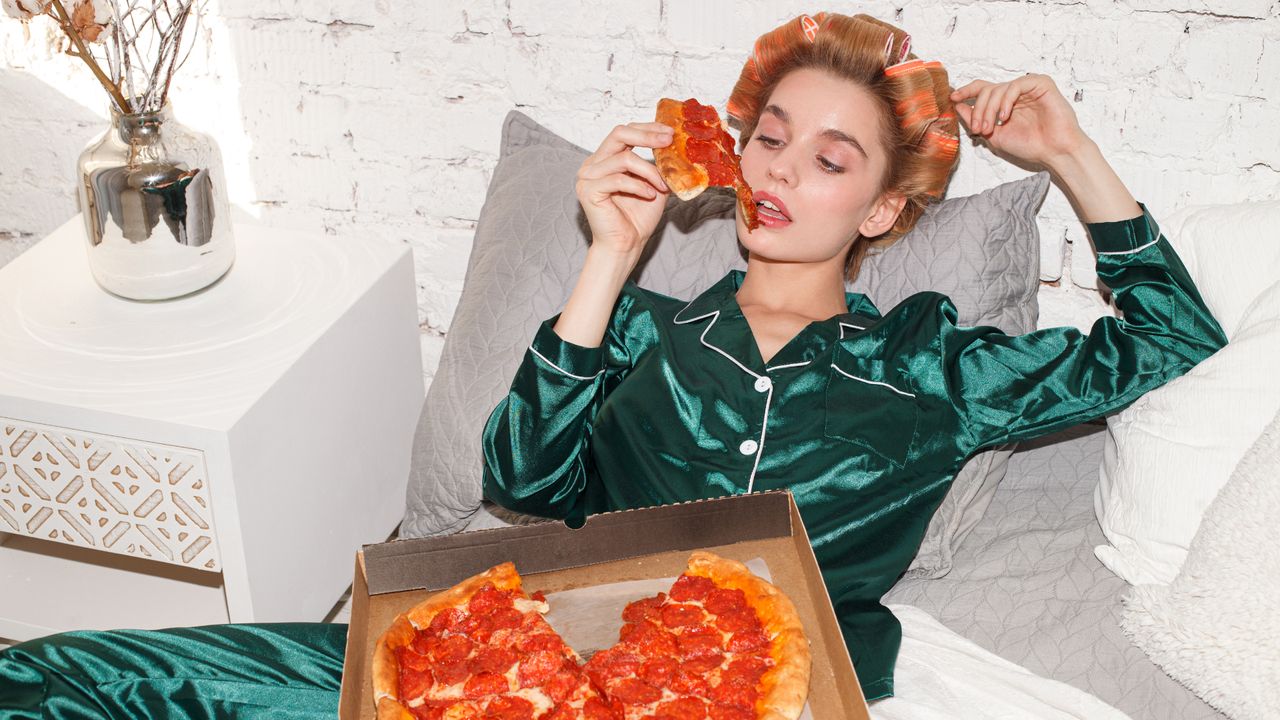 Woman lounges in silk pajamas