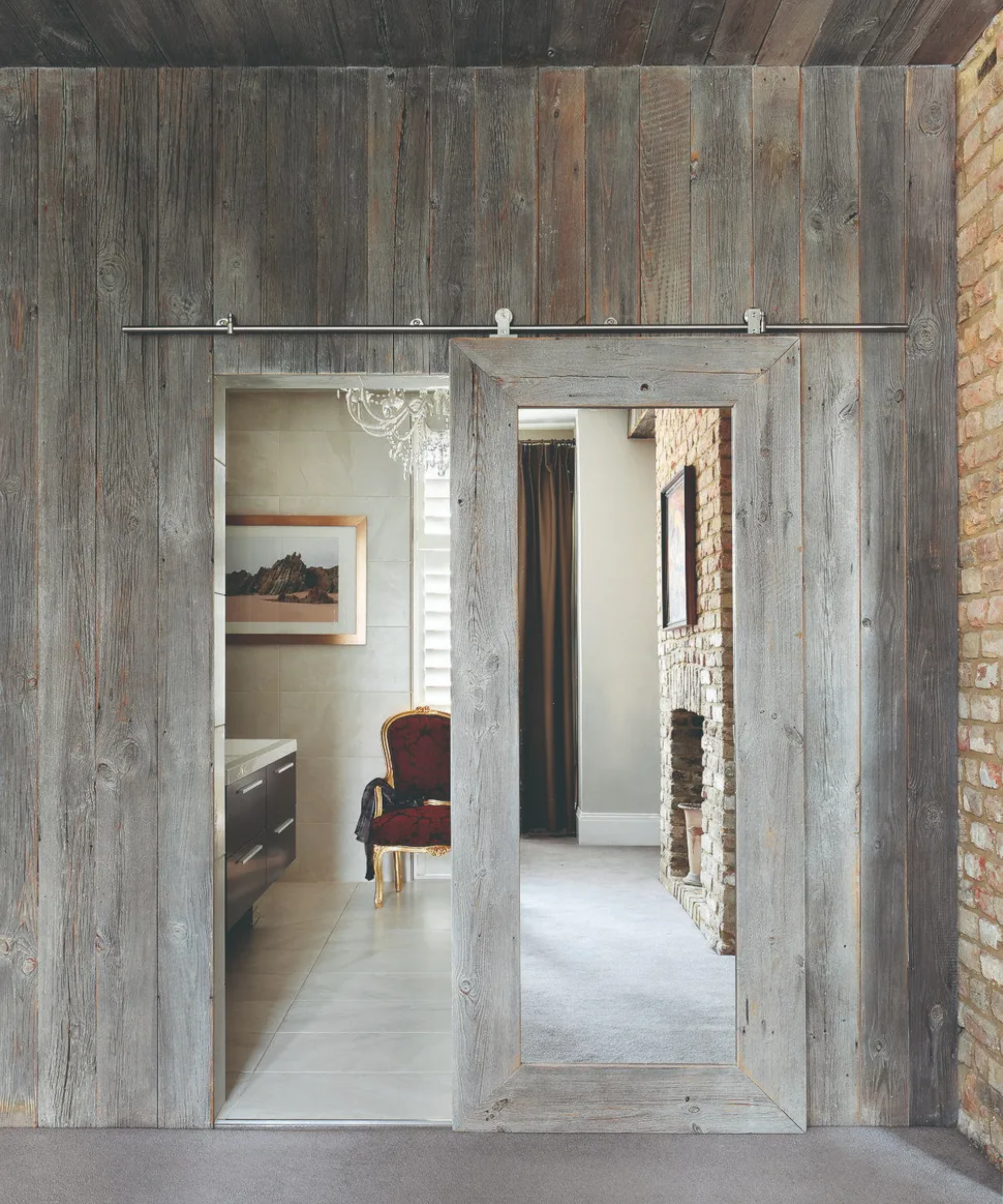 Room behind a sliding hiden door on a metal rail behind a wooden wall