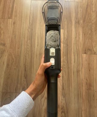 Opening the dustcap on the Shark Wandvac cordless handheld vacuum cleaner