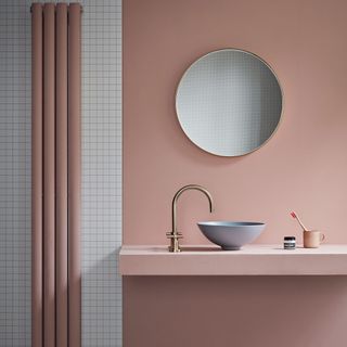 bathroom with mirror and pink wall