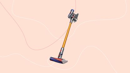 Dyosn V8 absolute vacuum cleaner on a pink background