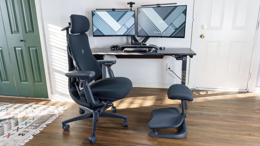 The LiberNovo Omni office chair with the LiberNovo StepSync footrest in front of a dual-monitor desk setup