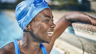 Young woman in swimming pool wearing swimming cap