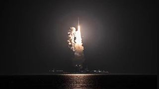 A Long March 11 rocket rises off a sea barge and into the night sky on Oct. 7, 2022.