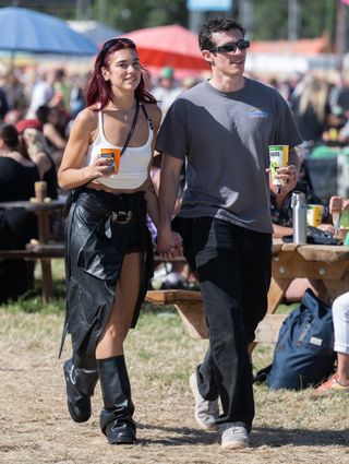 GLASTONBURY, ENGLAND - JUNE 29: Dua Lipa and Callum Turner during day four of Glastonbury Festival 2024 at Worthy Farm, Pilton on June 29, 2024 in Glastonbury, England. Founded by Michael Eavis in 1970, Glastonbury Festival features around 3,000 performances across over 80 stages. Renowned for its vibrant atmosphere and iconic Pyramid Stage, the festival offers a diverse lineup of music and arts, embodying a spirit of community, creativity, and environmental consciousness. (Photo by Samir Hussein/WireImage)