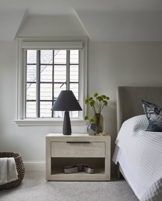 A bedroom with a nightstand and a sidetable