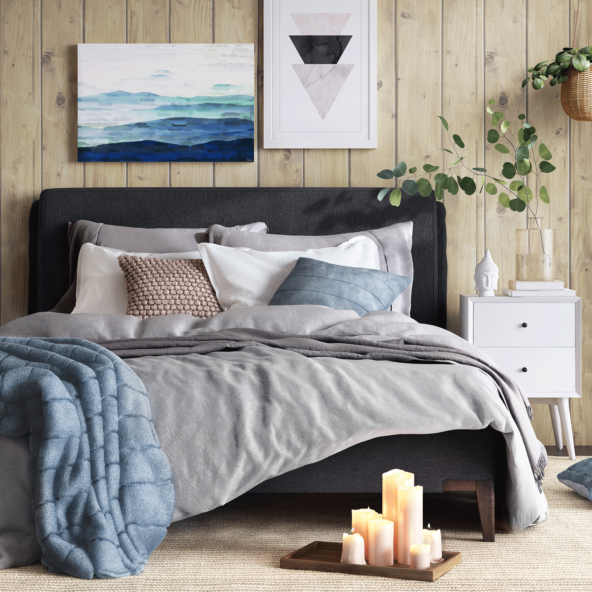 Grey bed with blankets and white walls