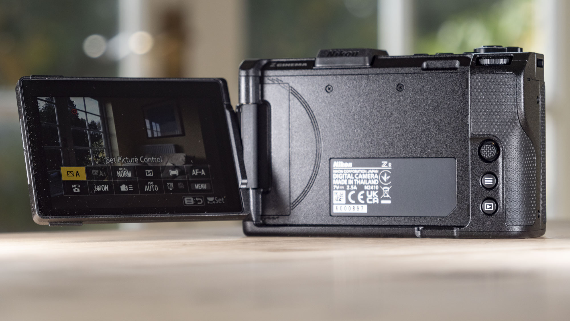 Nikon ZR product photos – camera on a wooden tablem screen flipped out