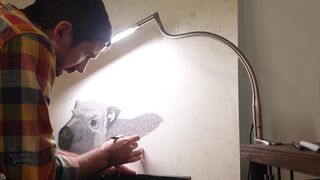 A photo of a man drawing with a light